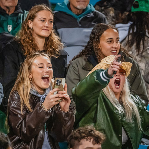 Fans cheering at Homecoming game