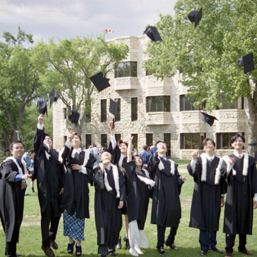 graduates on campus outside