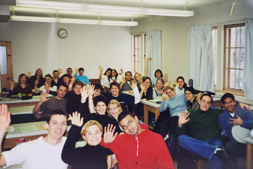Classroom full of student waving