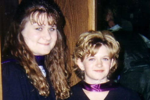 two female students in grad gowns